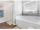 Bright bathroom featuring a large soaking tub, shower, and window at 445 Sawmill Trce, Hampton, GA 30228