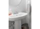 Pedestal sink in a half bathroom with round mirror and grey paint at 445 Sawmill Trce, Hampton, GA 30228
