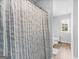 The view of the toilet, window, and sink, from inside the walk-in shower at 445 Sawmill Trce, Hampton, GA 30228