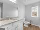 This bathroom has granite countertops, white cabinets, and wood-look tile flooring at 445 Sawmill Trce, Hampton, GA 30228