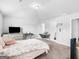 Bright bedroom featuring neutral walls, a cozy bed, and a television at 445 Sawmill Trce, Hampton, GA 30228