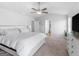 Spacious bedroom features a ceiling fan, large bed and white dresser at 445 Sawmill Trce, Hampton, GA 30228