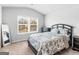 This bedroom features a comfortable bed, neutral decor and natural light from the window at 445 Sawmill Trce, Hampton, GA 30228