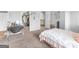 Bright bedroom featuring neutral walls, a cozy bed, and access to the hallway at 445 Sawmill Trce, Hampton, GA 30228