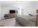 A bedroom featuring neutral colors, a large television, and a comfortable chair at 445 Sawmill Trce, Hampton, GA 30228