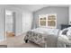 Bright bedroom featuring neutral walls, a bed, and ample natural light from a window at 445 Sawmill Trce, Hampton, GA 30228
