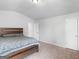 A bedroom with neutral colors, carpet floors, and a bed with decorative pillows at 445 Sawmill Trce, Hampton, GA 30228