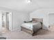 Bedroom view of a neutral-toned room with carpet, bed, and doorways to other rooms at 445 Sawmill Trce, Hampton, GA 30228