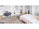 Bright bedroom featuring neutral walls, a cozy bed, and access to the hallway at 445 Sawmill Trce, Hampton, GA 30228