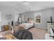 Bright bedroom featuring neutral walls, a cozy bed, and ample natural light from a window at 445 Sawmill Trce, Hampton, GA 30228