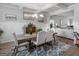 Elegant dining room with stylish chairs, a modern chandelier, and hardwood floors at 445 Sawmill Trce, Hampton, GA 30228