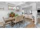 Bright dining room featuring a coffered ceiling, stylish chandelier, and an open floor plan at 445 Sawmill Trce, Hampton, GA 30228