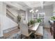 Spacious dining room with a modern chandelier, stylish chairs, and staircase nearby at 445 Sawmill Trce, Hampton, GA 30228