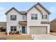 Charming two-story white brick home with a well-manicured lawn, perfect for a growing Gathering at 445 Sawmill Trce, Hampton, GA 30228