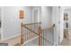Carpeted upstairs hallway with wood and black railing at 445 Sawmill Trce, Hampton, GA 30228