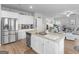 Open kitchen with large island featuring granite countertops, a sink, and modern stainless steel appliances at 445 Sawmill Trce, Hampton, GA 30228