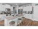 Bright, open kitchen with large island, bar stool seating, stainless appliances, and neutral granite counter tops at 445 Sawmill Trce, Hampton, GA 30228