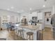 Modern kitchen featuring an island with granite countertops, wooden stools, stainless steel appliances and fixtures at 445 Sawmill Trce, Hampton, GA 30228