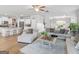 Open-concept living area connecting the kitchen and dining, with hardwood floors and ample seating at 445 Sawmill Trce, Hampton, GA 30228