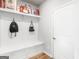 Mudroom features a storage bench with coat hooks for convenient organization near the entry at 445 Sawmill Trce, Hampton, GA 30228