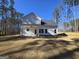 Back of house showing a white exterior, a covered patio, and a large backyard at 746 S. Bethany Rd., Locust Grove, GA 30248