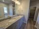 Primary bathroom featuring a double vanity with granite countertops, a large mirror, and a separate shower at 746 S. Bethany Rd., Locust Grove, GA 30248