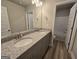 Bathroom showcasing double sinks with granite countertops and wood-look flooring at 746 S. Bethany Rd., Locust Grove, GA 30248