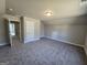 Large bonus room with neutral paint, plush carpet, and multiple doors and closets at 746 S. Bethany Rd., Locust Grove, GA 30248