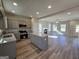 Spacious kitchen featuring an island, stainless appliances, recessed lighting and a view into the living room at 746 S. Bethany Rd., Locust Grove, GA 30248