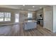 Modern kitchen featuring an island, granite countertops, stainless steel appliances, and gray cabinetry at 746 S. Bethany Rd., Locust Grove, GA 30248