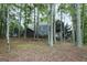 Exterior view of home from backyard showing screened porch and view of the lake at 2770 Stonehill Way, Cumming, GA 30041