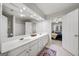 Bright bathroom featuring double vanity with white cabinets and a large mirror with views to a bedroom at 2770 Stonehill Way, Cumming, GA 30041