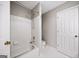 Well-lit bathroom showcasing a bathtub, shower, toilet and a white tiled wall and floor at 2770 Stonehill Way, Cumming, GA 30041