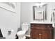 Elegant half bath with vintage-style vanity and decorative mirror at 2770 Stonehill Way, Cumming, GA 30041