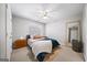 Cozy bedroom featuring neutral walls, a ceiling fan and a plush bed with a blue accent blanket at 2770 Stonehill Way, Cumming, GA 30041