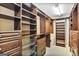 Spacious walk-in closet with custom built-in shelving, drawers, and storage solutions at 2770 Stonehill Way, Cumming, GA 30041