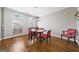 Bright dining room with hardwood floors, large windows, and seating for six around a square wooden table at 2770 Stonehill Way, Cumming, GA 30041