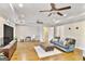 Open living room featuring hardwood floors, comfortable seating, and ample natural light from large windows at 2770 Stonehill Way, Cumming, GA 30041