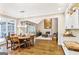 Open-concept living and dining area, featuring hardwood floors and a cozy fireplace at 2770 Stonehill Way, Cumming, GA 30041