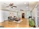 Spacious living room with hardwood floors, recessed lighting, and a comfortable gray sofa and ottoman at 2770 Stonehill Way, Cumming, GA 30041