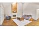 Cozy living room with a fireplace, vaulted ceiling, hardwood floors, and comfortable seating arrangements at 2770 Stonehill Way, Cumming, GA 30041