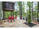 Stone patio with dining table and chairs provides space to relax by the lake at 2770 Stonehill Way, Cumming, GA 30041