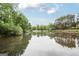 Calm water reflects the trees and sky, creating a peaceful landscape at 2770 Stonehill Way, Cumming, GA 30041