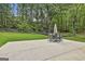 Spacious backyard featuring a patio area, outdoor seating, and a lush green lawn surrounded by trees at 306 N Meade Dr, Peachtree City, GA 30269
