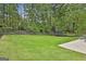 Backyard featuring an expansive grassy area with a trampoline and a concrete patio space at 306 N Meade Dr, Peachtree City, GA 30269