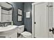 Stylish bathroom showcasing a modern vanity, toilet, framed pictures, and subway tile shower at 306 N Meade Dr, Peachtree City, GA 30269