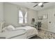 Bedroom with a white bed, desk, ceiling fan, and natural lighting at 306 N Meade Dr, Peachtree City, GA 30269