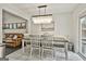 Bright dining room with modern light fixture and access to living area at 306 N Meade Dr, Peachtree City, GA 30269