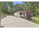 Home exterior features long driveway, manicured landscaping, and an American flag at 306 N Meade Dr, Peachtree City, GA 30269