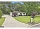 Well-maintained home with a long driveway, manicured lawn, and classic mailbox at 306 N Meade Dr, Peachtree City, GA 30269